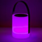 A glowing purple lantern with a cylindrical shape and a black handle, illuminating a dark background.
