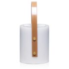 A cylindrical white lantern with a brown leather handle and two brass buttons. The lantern has a minimalist design and provides a soft glow, perfect for indoor or outdoor settings.