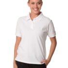 Person smiling, wearing a white polo shirt and dark pants, standing against a plain white background.