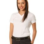 Woman smiling, wearing a white polo shirt and black pants against a white background.