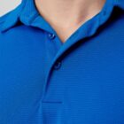 Close-up of a person wearing a blue polo shirt with a textured pattern.