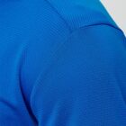 Close-up of a textured blue fabric shirt shoulder and sleeve.