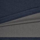 Close-up of layered navy and gray fabric with textured and dotted patterns.
