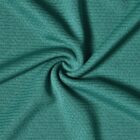 Close-up of green textured fabric twisted into a spiral.