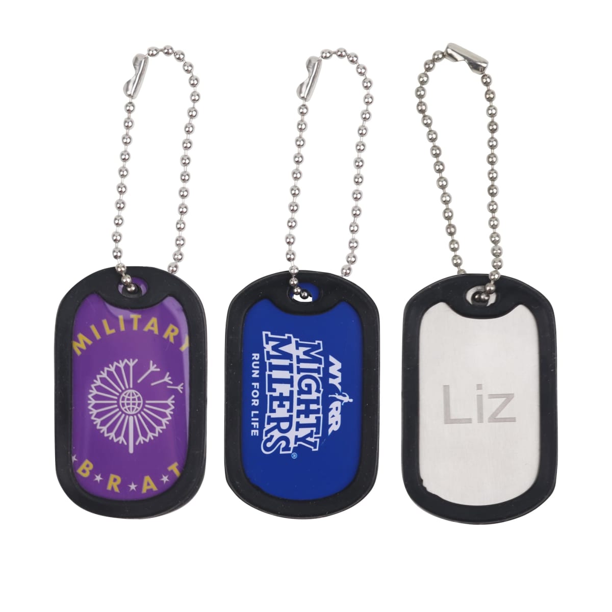 Three dog tags on ball chains: left is purple with MILITARY BRAT and pinwheel design, center is blue with MIGHTY MITES RUN FOR LIFE logo, right is silver with Liz engraved.
