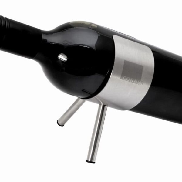 A wine bottle standing horizontally on a sleek metal holder with two legs, positioned at an angle. The bottle has a dark label, and the holder features a brushed metal finish. The background is white, emphasizing the modern and minimalist design.