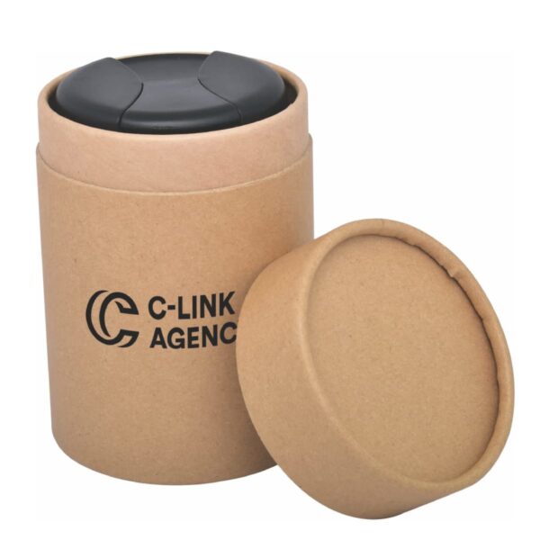 A cylindrical cardboard container with the lid removed, revealing an object with a black surface inside. The container is labeled C-LINK AGENCY in black text. The lid is placed leaning against the container.