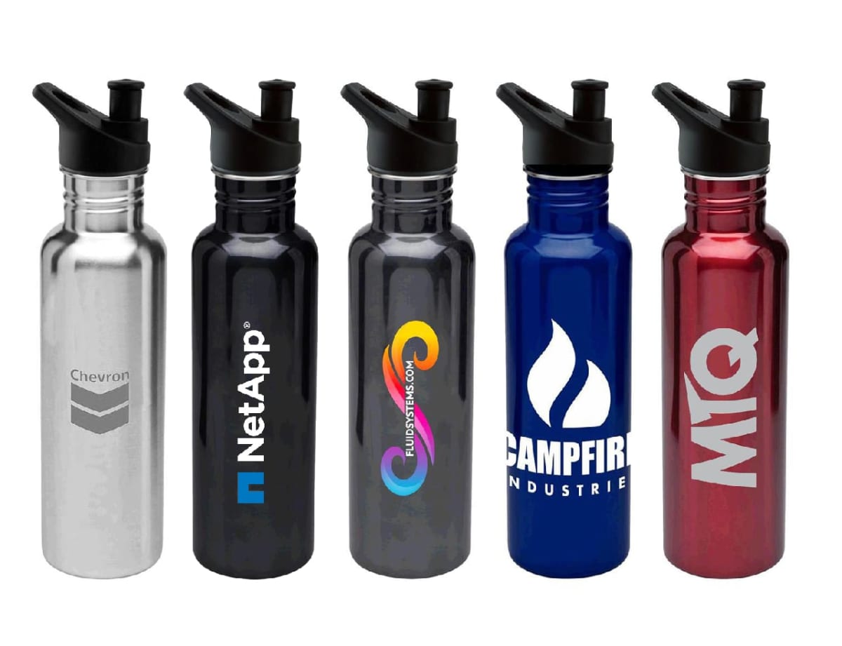 Five stainless steel water bottles with black lids and straws, each in a different color: silver, black, dark gray with a multicolored logo, blue with a white flame logo, and red with MQ logo. Each bottle has a unique company logo printed on it.
