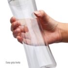 A hand holding a clear water bottle with a green cap. The bottle has an hourglass shape for easy grip. A red label at the bottom says BPA free!.