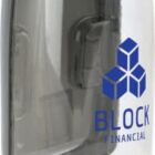A transparent water bottle with a grey lid and an attached grey handle. It features a logo with blue geometric shapes and the text BLOCK FINANCIAL printed on it.