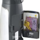 A transparent water bottle with a gray flip-top lid, featuring an open compartment on its side containing folded euro currency and a key, highlighting its multifunctional design.