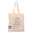 A beige tote bag with a black outline of a stocking filled with gifts and a teddy bear. The design includes stars and a bow. Below the bag is a pack of colorful crayons.