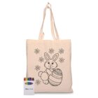 A beige tote bag featuring an outline of a smiling bunny holding an Easter egg, surrounded by flowers. A pack of crayons is placed beside the bag, labeled with Disney Pixar.