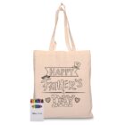 A beige tote bag with the words Happy Fathers Day printed on it, including a top hat, mustache, and hearts. A box of Disney Pixar crayons is placed beside the bag.