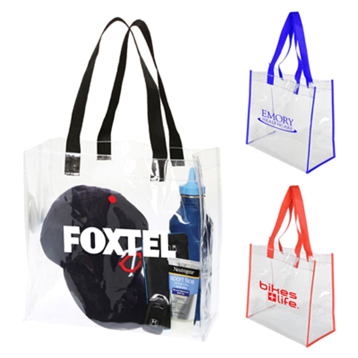 Three transparent tote bags with black, blue, and red handles. The black-handled bag contains various items, including a cap and a bottle. Logos on the blue and red-handled bags read EMORY and bikes life respectively.