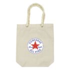 A beige tote bag with rope handles features the Converse All Star logo. The logo has a red star in the center with the words Converse All Star Chuck Taylor encircled in blue.