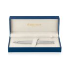 A silver pen is displayed inside a blue and beige Waterman Paris box. The pen rests on a plush, cushioned interior, designed for presentation or gift-giving.