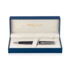 A black and silver pen is elegantly displayed in an open blue and beige box with Waterman Paris in gold lettering. The interior is lined with soft material for protection and presentation.