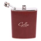 A brown leather-wrapped hip flask with Callia Magna written on it in white text. The cap is open and attached by a hinge near the top. The flask has a stainless steel trim on the top and bottom edges.