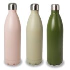 Three insulated water bottles with metal caps stand upright. They are in pastel pink, light beige, and dark green. The bottles have a sleek, smooth design with a slightly curved shape.