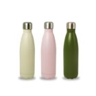 Three metal water bottles with silver caps are lined up. The bottles are matte and colored in cream, pink, and dark green from left to right. They are smooth, with a slightly tapered design and round bottoms.