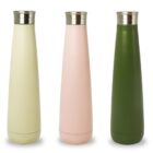 Three tall, slender stainless steel bottles with screw-on caps are displayed against a white background. The bottles are in pastel yellow, light pink, and dark green.