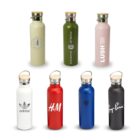 Seven reusable water bottles in varied colors with wooden caps and brand logos, including Converse, Lululemon, Lush, Adidas, H&M, Warner Bros., and Ray-Ban. They are arranged in two rows.