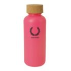 A bright pink bottle with a cork lid. The bottle features a black laurel wreath logo above the text Fred Perry.