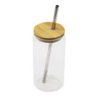 Clear glass tumbler with a bamboo lid and a metal straw inserted through the center. The straw extends both inside and outside the tumbler, which is empty and standing upright on a white background.