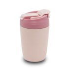 A light pink reusable cup with a pink lid featuring a flip-top closure. The cup is designed for hot or cold beverages, with a sleek and compact shape suitable for travel.