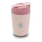 A cream-colored reusable coffee cup with a pink lid, featuring a gray apple logo on its side. The lid has a durable clip for securing the contents. The design is sleek and modern.