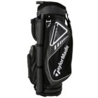 A black and gray TaylorMade golf bag with multiple zippered compartments, a sturdy handle, and the brand logo prominently displayed.