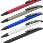 Five pens arranged diagonally, each with a metallic barrel and black clip. Colors include red, silver, blue, white, and black. The clip has CARBONCOPY written on it.