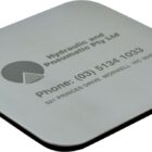 A gray square coaster with black edging. It features the logo and contact details for Hydraulic and Pneumatic Pty Ltd, including a phone number and address located in Morwell, Victoria.
