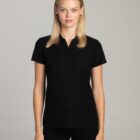 Woman wearing a short-sleeved black polo shirt standing against a plain light background.
