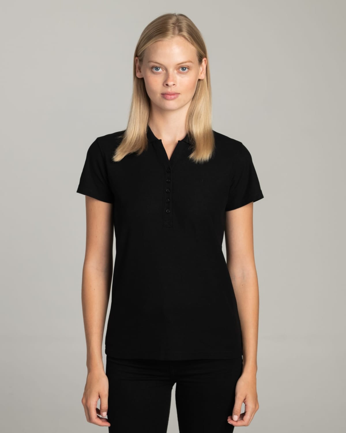 Woman wearing a short-sleeved black polo shirt standing against a plain light background.