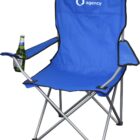 A blue folding camping chair with a cup holder containing a beer bottle. The chair has a logo with a water droplet and the words water agency on the backrest. The chair features gray metal legs.