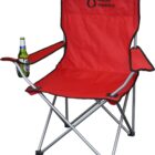 Red folding camping chair with a black frame, featuring a logo on the backrest. A bottle is placed in the cup holder on the right armrest.
