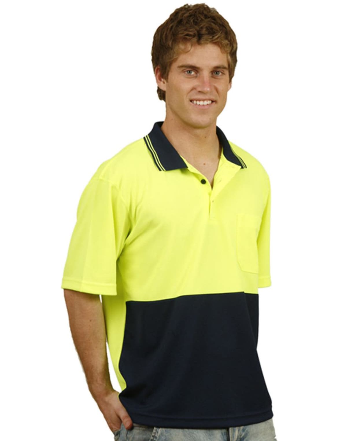 A person wearing a bright yellow and navy polo shirt with jeans smiles at the camera. The shirt has a collar and a pocket. The background is plain white.