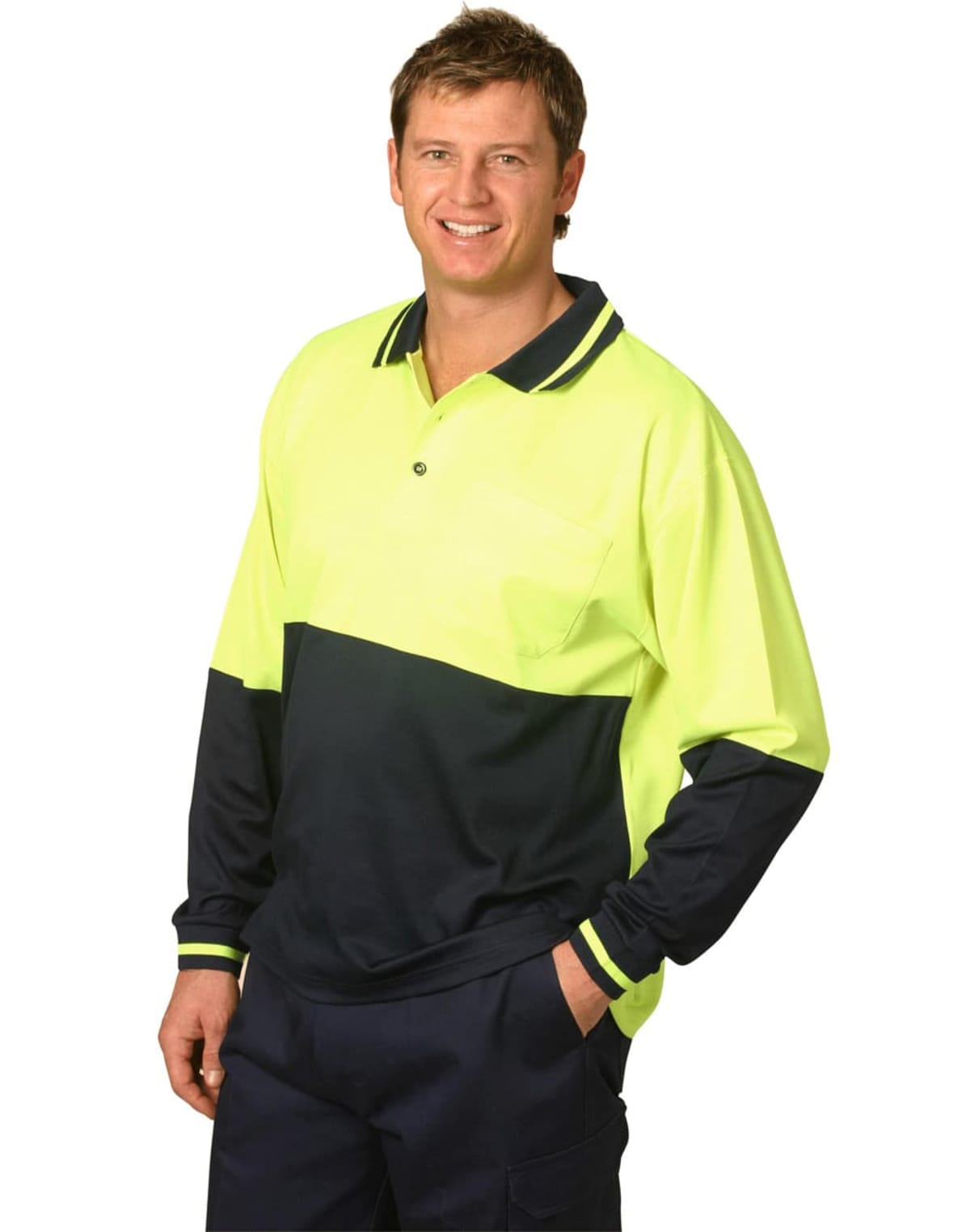 A person wearing a high-visibility, two-toned long-sleeve polo shirt in neon yellow and dark blue smiles with one hand in their pocket against a plain white background.