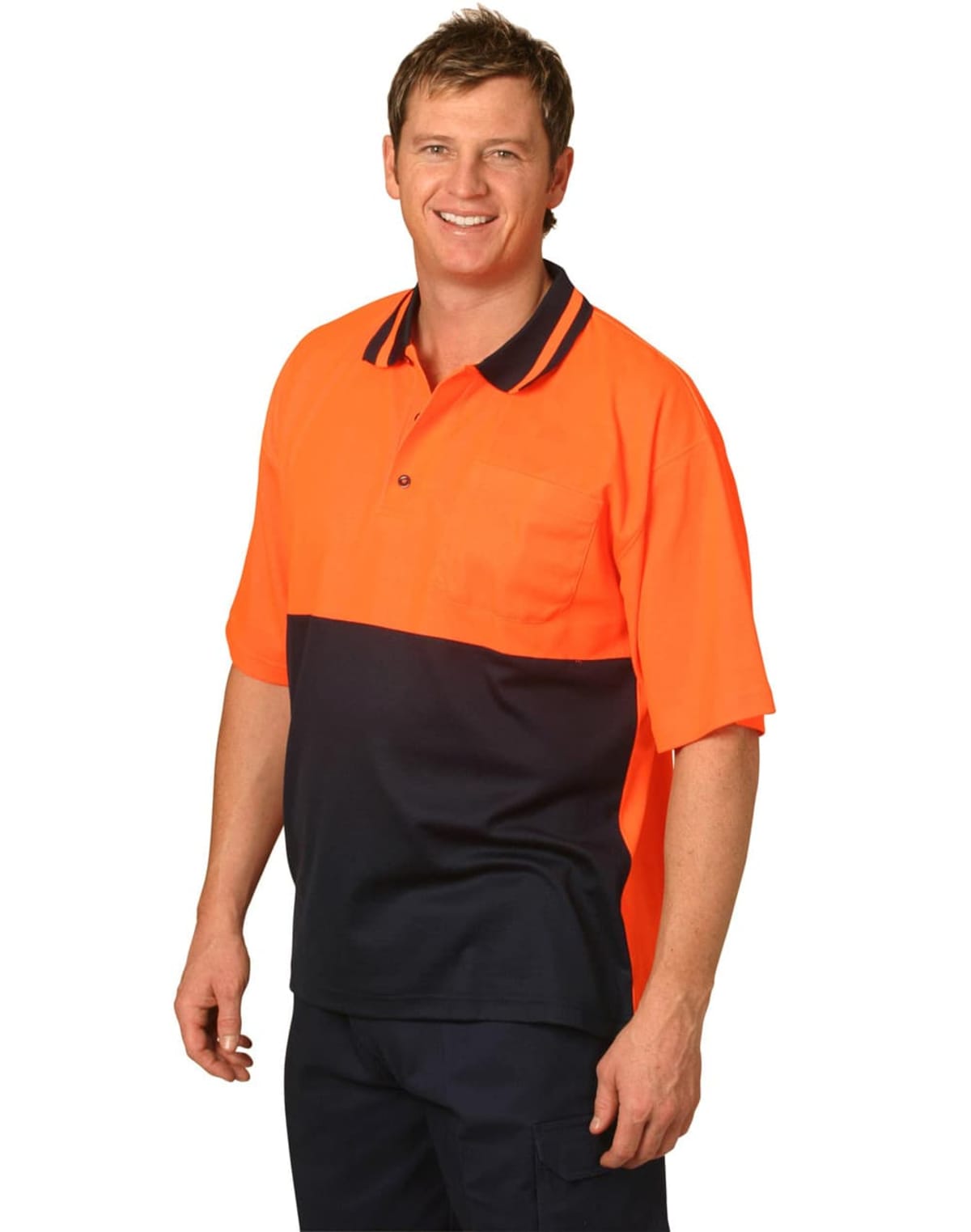 A person wearing an orange and navy blue work polo shirt stands smiling.