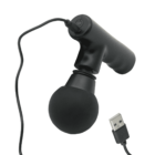A black handheld massager with a round rubber head and long handle, featuring a USB cable extending from the top for charging or power.