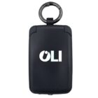 A black rectangular device with rounded edges, featuring the white logo OLI on the front. It has a metallic ring attached at the top, resembling a keychain accessory.
