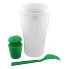 A tall, white plastic container with a lid is shown. Beside it is a small green container with a green lid, partially opened, and a green utensil that combines a fork and spoon.