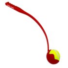 A red ball launcher with a curved handle and a tennis ball secured in the scoop end. The words Royal Canin are printed on the handle. The tennis ball is yellow with a red casing partially around it.