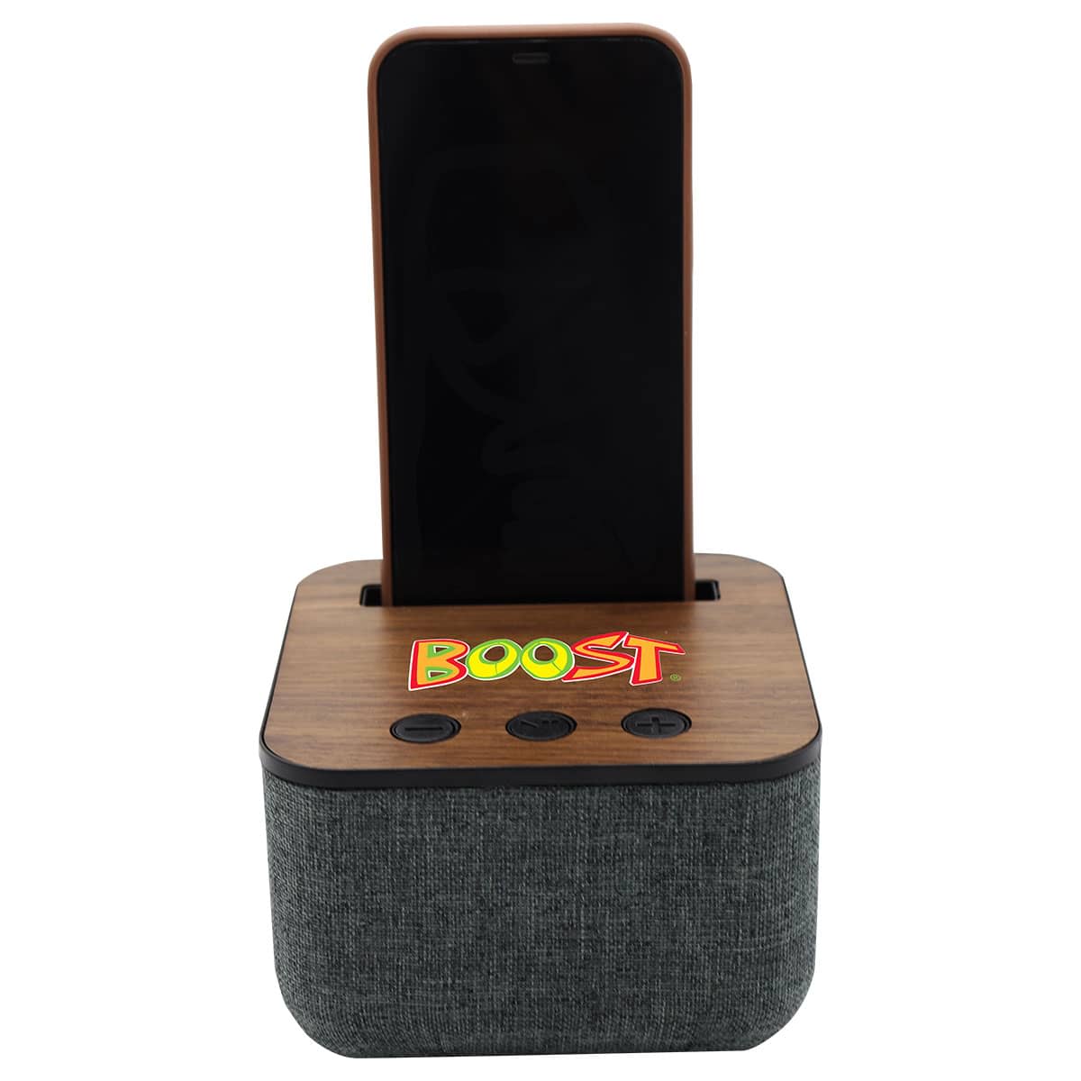A wooden and fabric speaker with a smartphone docked on top. The word BOOST is colorfully printed on the wood panel. There are three buttons below for audio control. The fabric is a textured dark gray.