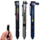 Three tactical pens in black, gray, and blue with clips and varying logos, including Survival Gear and Built to Survive. A hand holds a compact pen-sized tool with a capped top, showing a compass on the end.