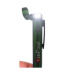 A green penlight with a clip reading inPixel is turned on, emitting a bright light. The top of the penlight is swivelled open, and a thumb is partially visible holding the penlight.