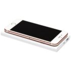 A smartphone with a rose gold trim and white front is placed on a white rectangular portable power bank. The phones screen is black, and both devices are positioned on a white background.