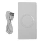 A rectangular white power bank with a circular wireless charging pad in the center is displayed next to a coiled white USB charging cable. The image shows the top view of both items.